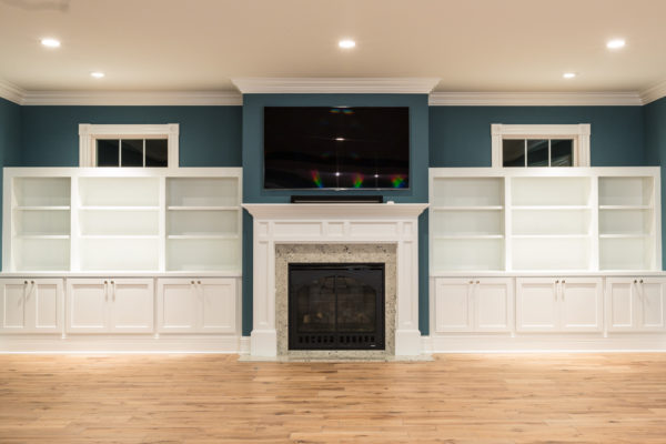 These Bookcases have three sections of open shelving above the counter and cabinet doors below. Also 2 transom windows above the Bookcases 