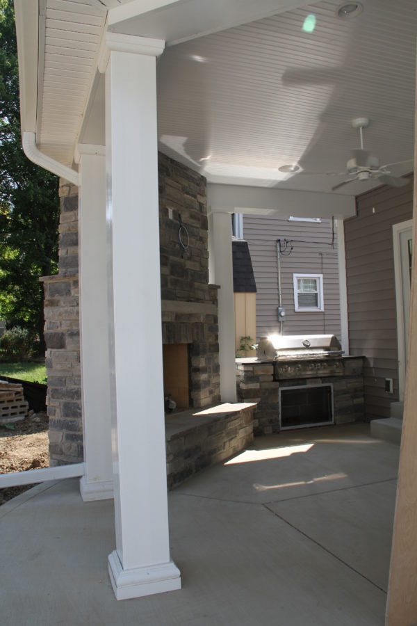 Covered porch with masonry outdoor fieplace