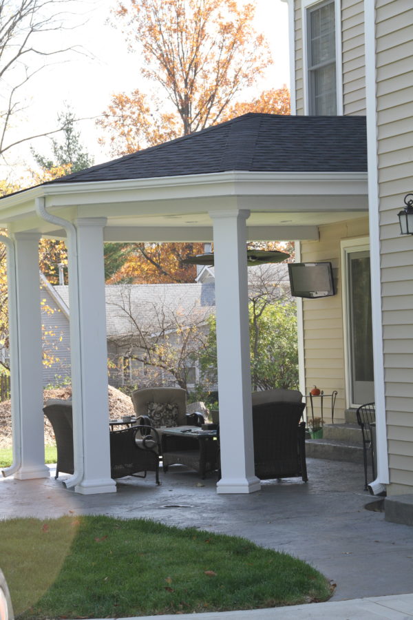 Covered porch with outdoor TV and seating .Sliding door opens to the Family Room