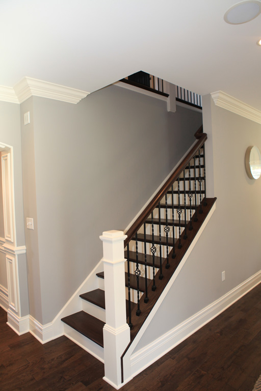 Custom painted newel post and staircase with stained hardwood treads