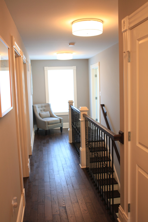 Second floor hallway with hardwood flooring