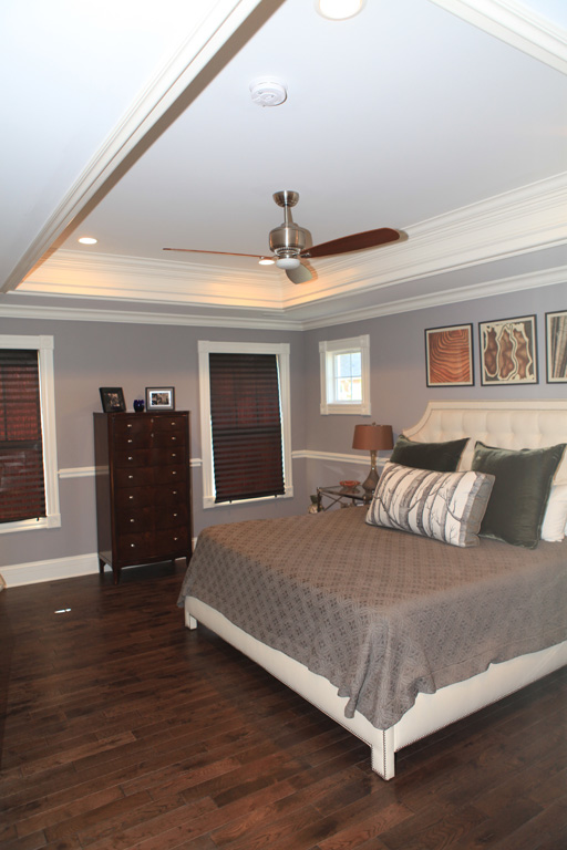 Master bedroom with tray ceiling and crown molding both inside and outside the tray