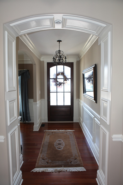 Foyer with single crown molding and wainscoting