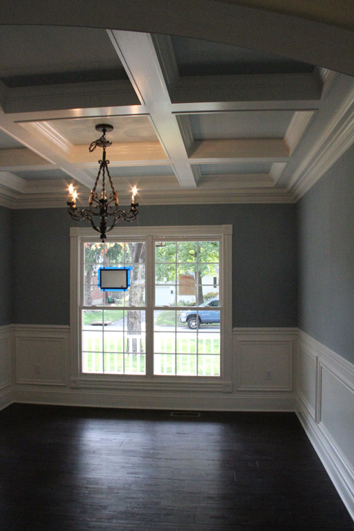 Box Beam ceiling in Dining Room with chandelier in the center of the room