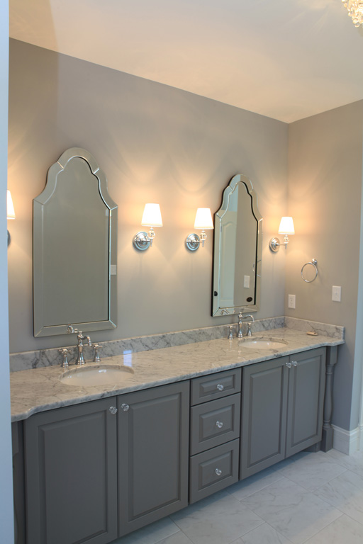 Master vanity with sconces and custom mirrors with white ceramic under mounted bowls