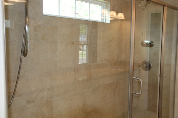 Oversized Master shower with transom window and 2 shower heads