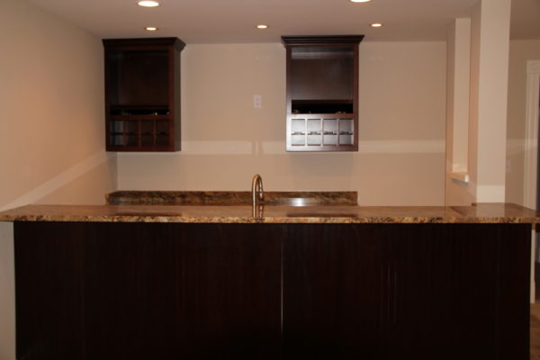 LL Bar with custom cabinetry for wine storage and 2 level bar with seating for stools