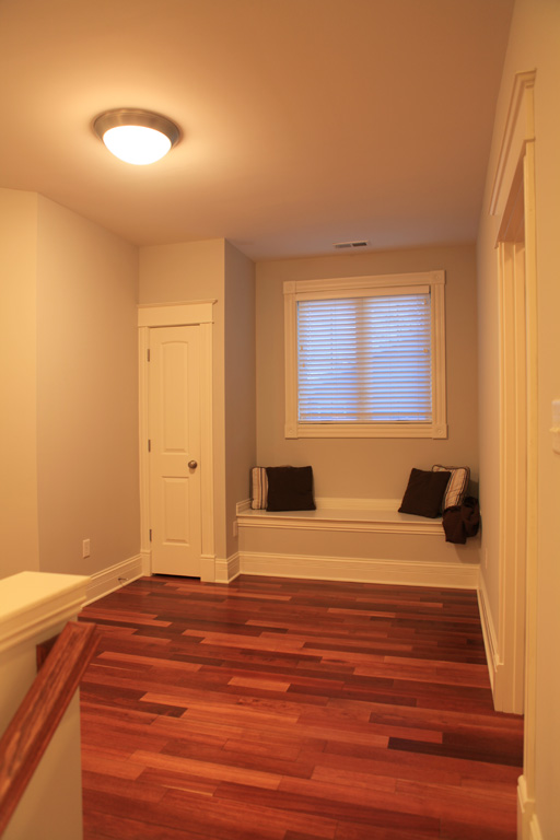 Window seat with small closet on the second floor landing
